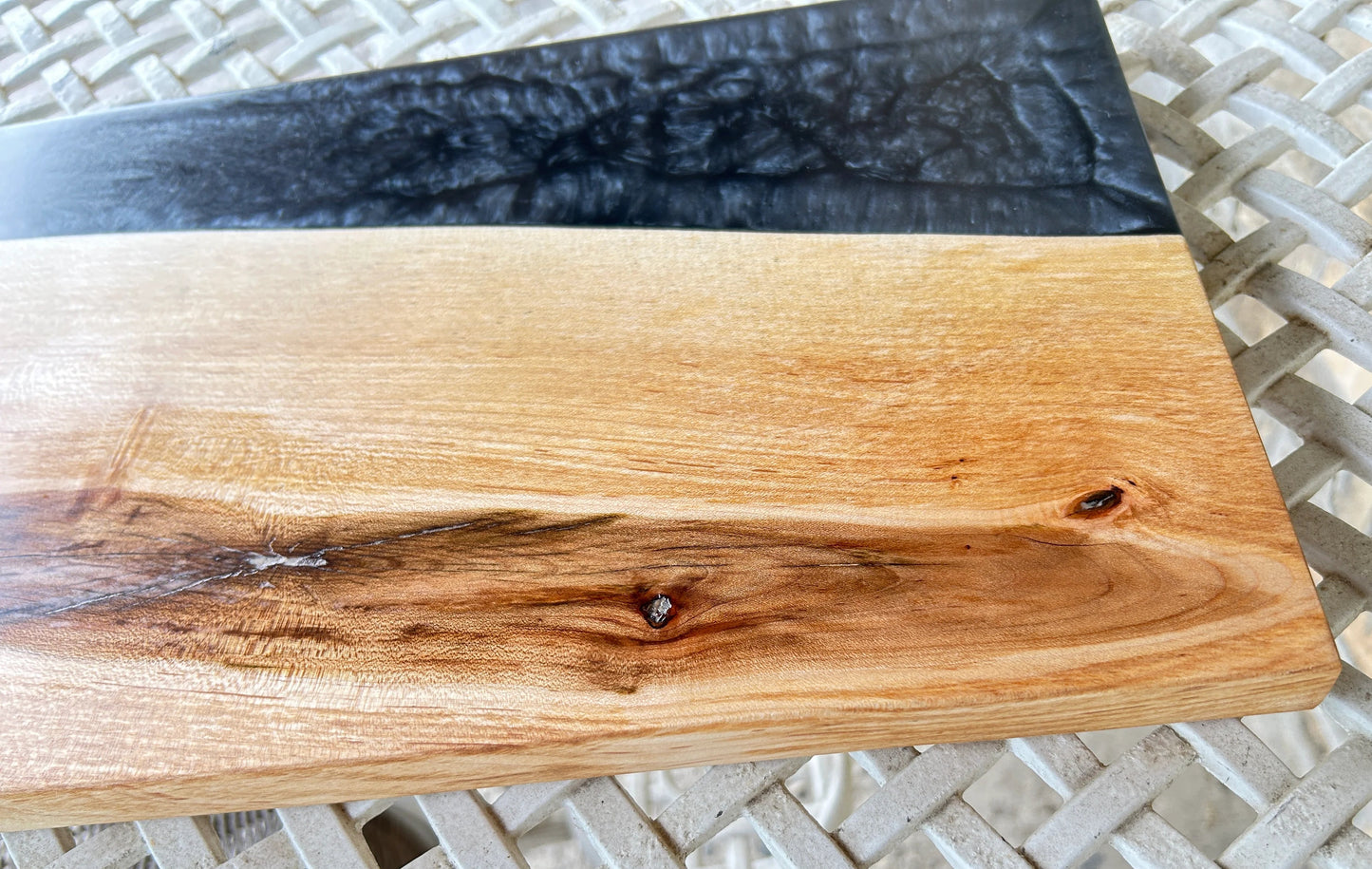 Wooden cutting board with black resin edge