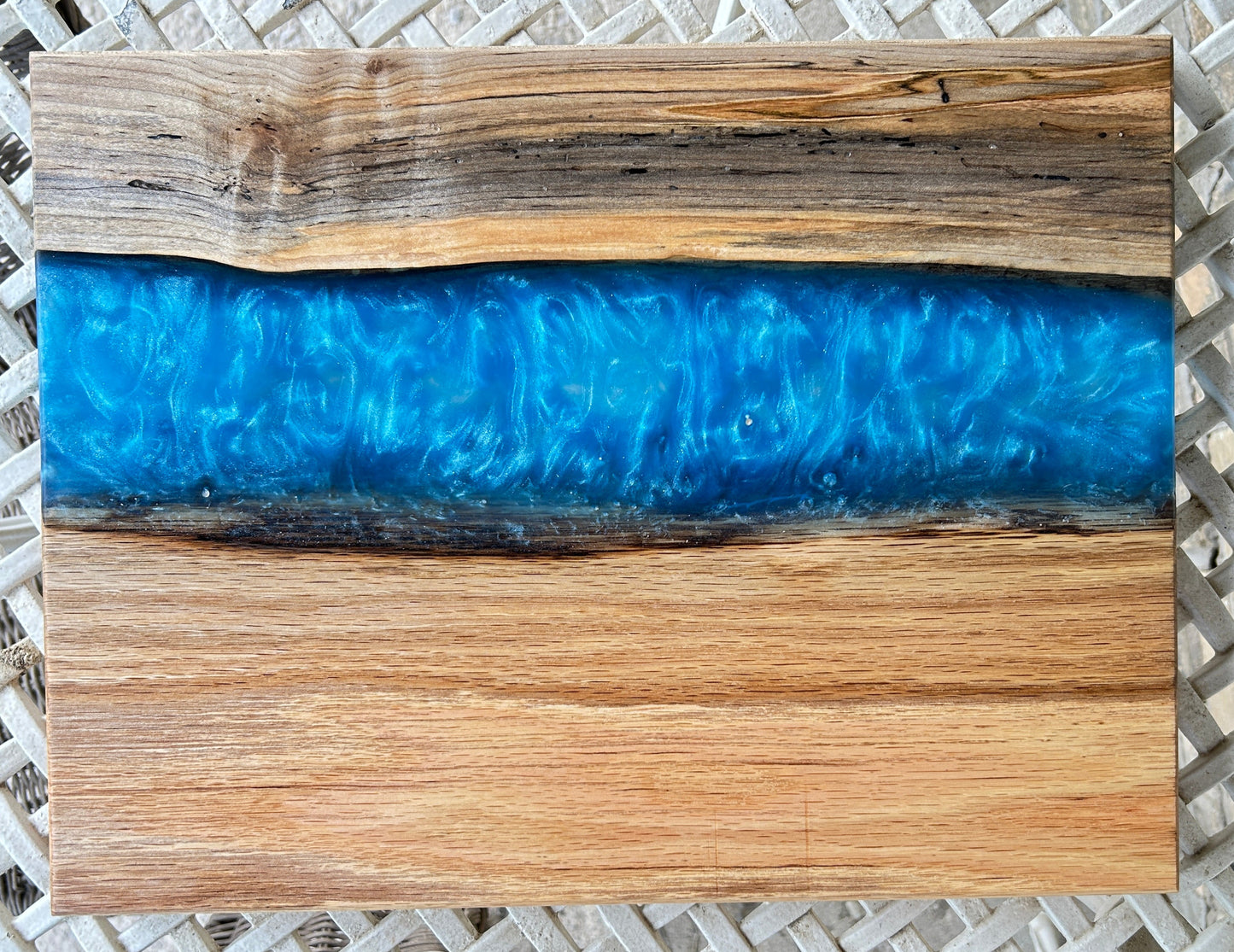 Wooden cutting board with blue resin