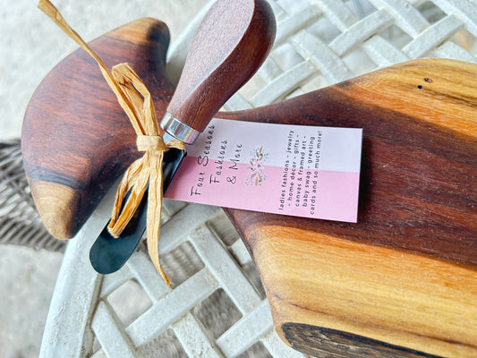 Wooden cutting board with cheese spreader