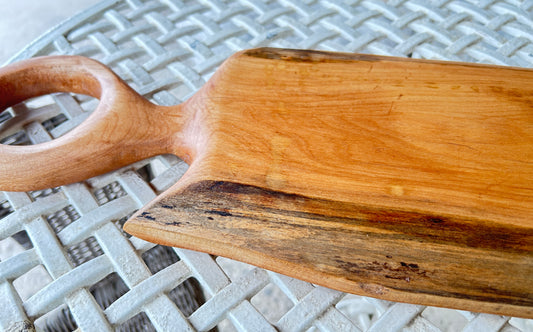 Wooden cutting board with a handle