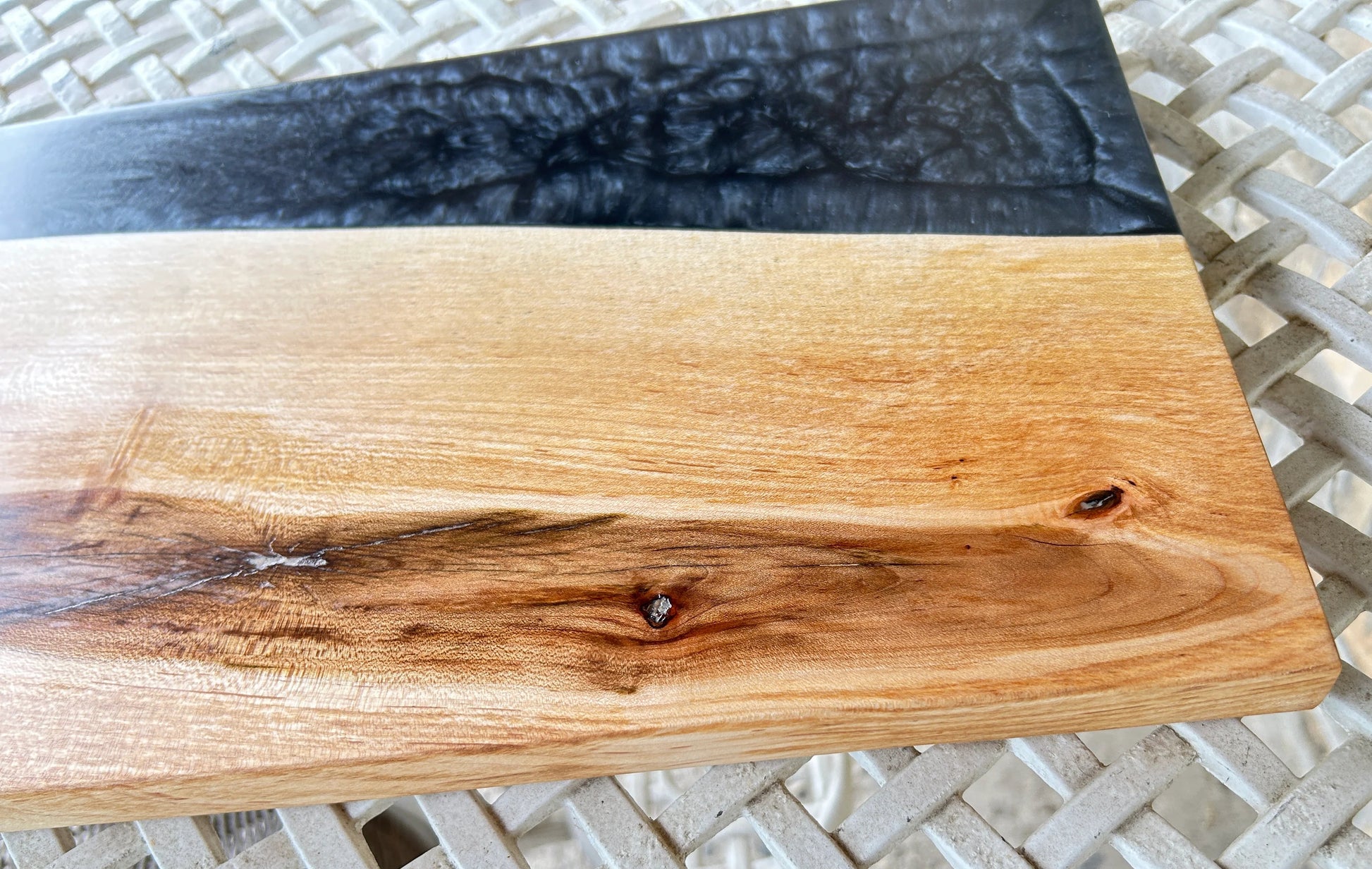 Wooden cutting board with black resin edge