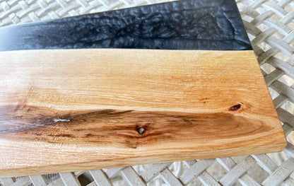 Wooden cutting board with black resin edge