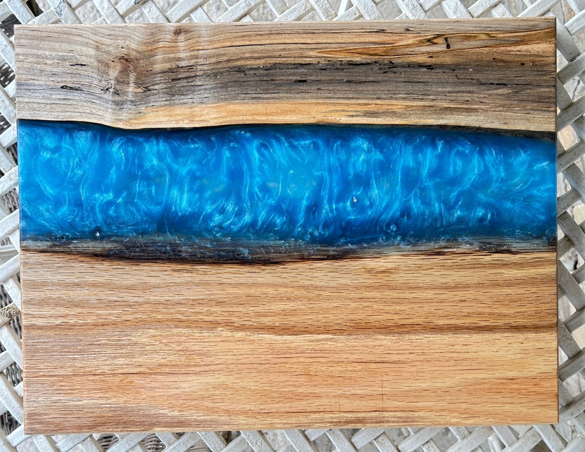 Wooden cutting board with blue resin