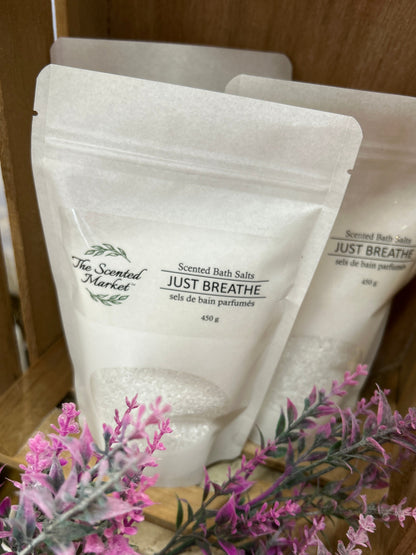 Scented bath salts packaging with lavender flowers on a wooden shelf
