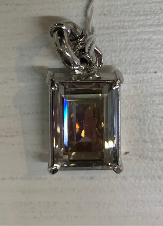 Silver pendant with a rectangular gemstone on a white background