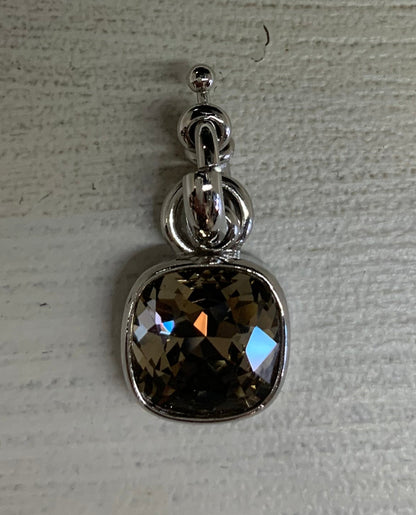 Silver pendant with a gemstone on a light gray background