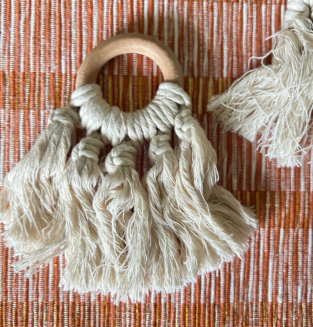 wood fringed napkin ring on orange placemat