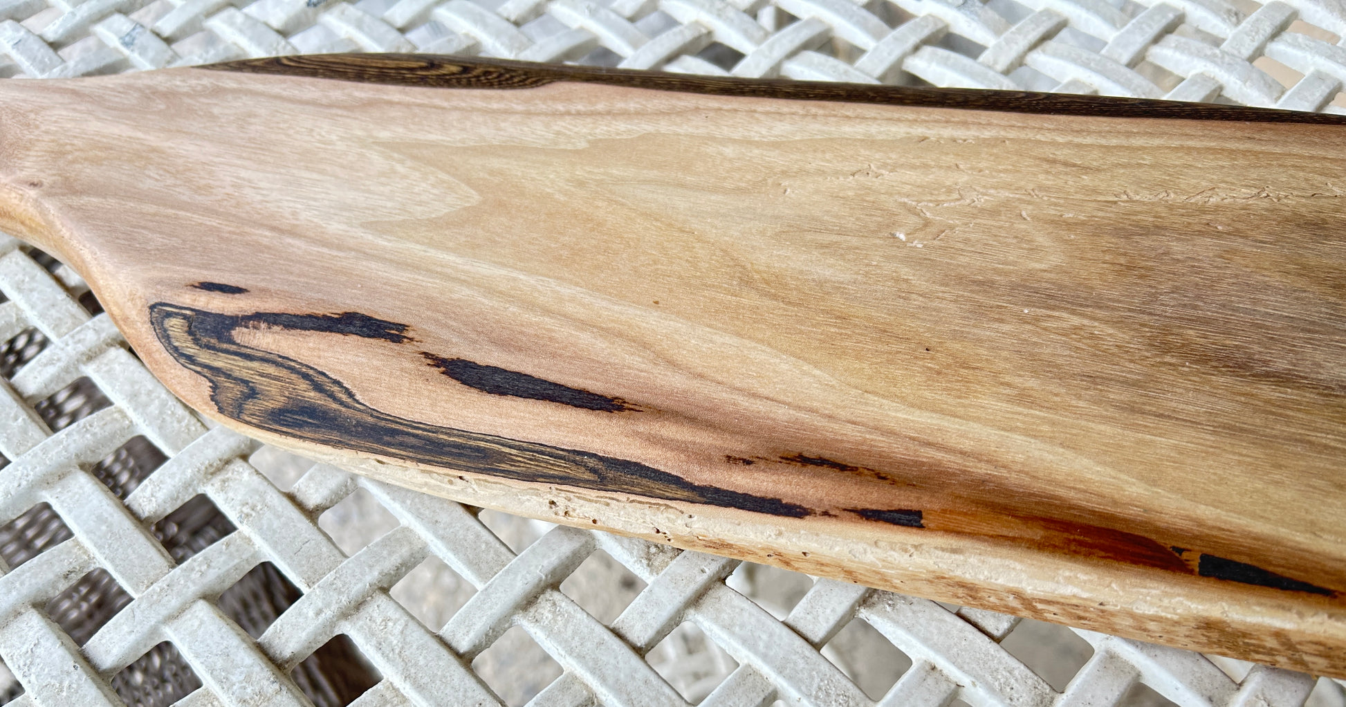 Close-up of a wooden surface with natural grain and dark spots 