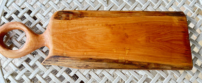 Wooden cutting board with a round handle