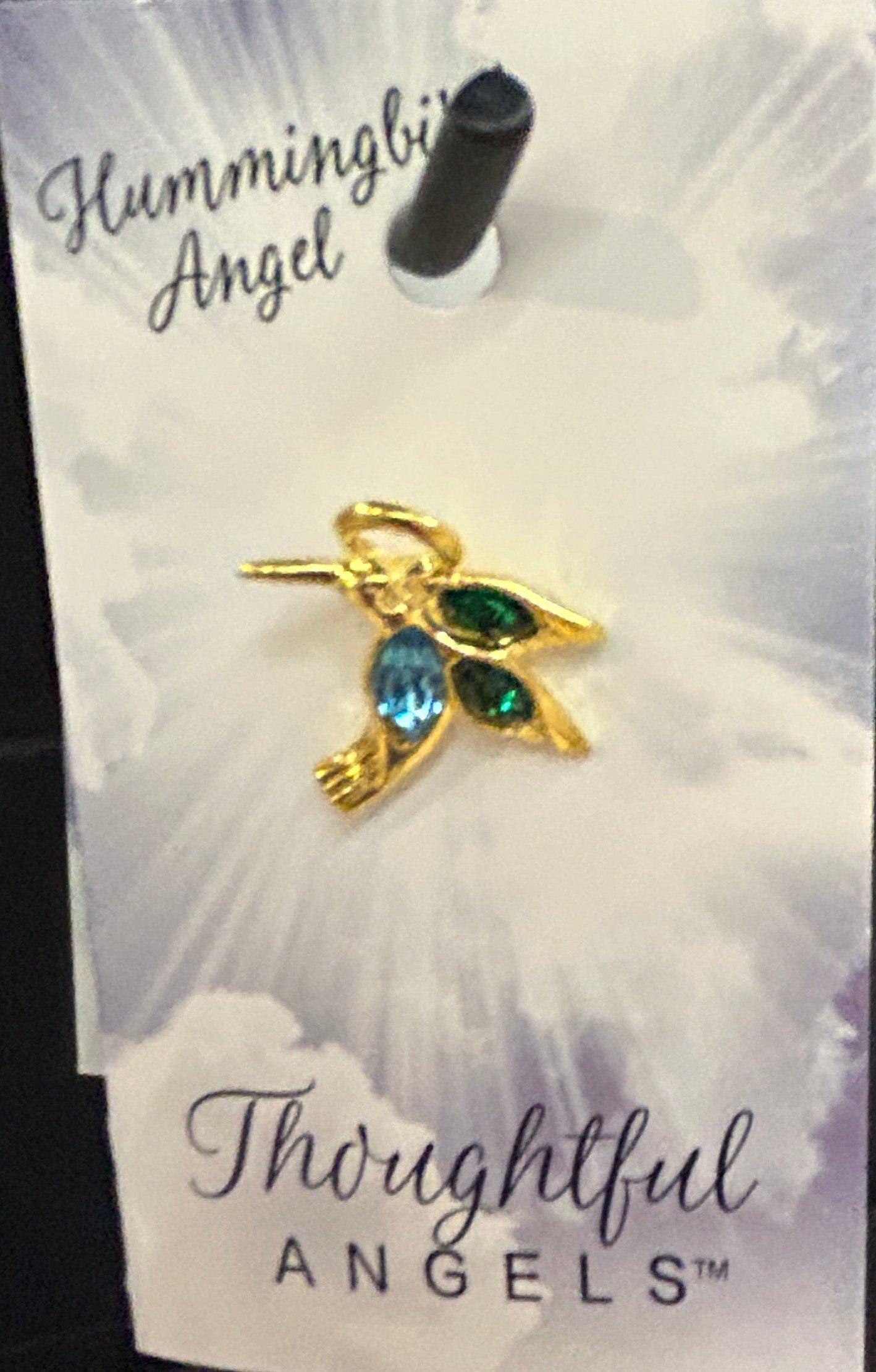 Gold angel pin with green gemstones on a Thoughtful Angels card.