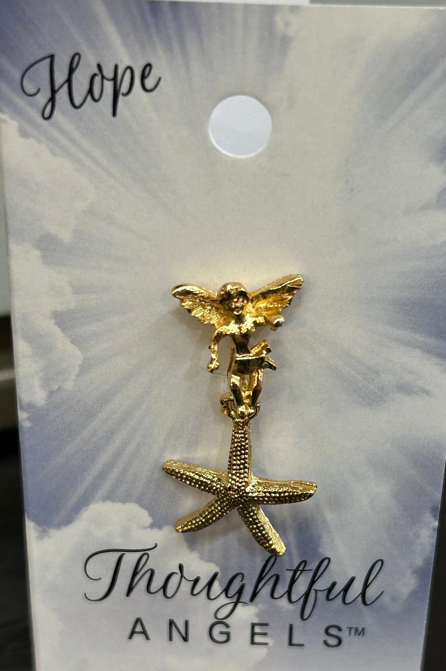Gold starfish earring on a 'Thoughtful Angels' branded card with 'Hope' written on it.