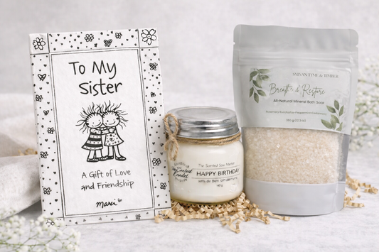 Gift set with candle, bath salts, and card on a white background