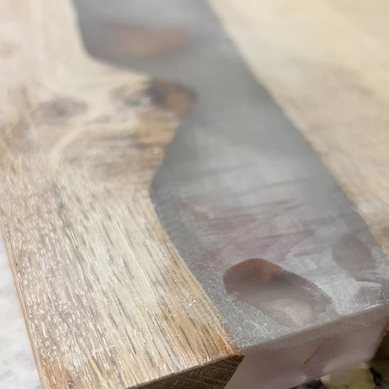 charcuterie board with leaves inside clear epoxy