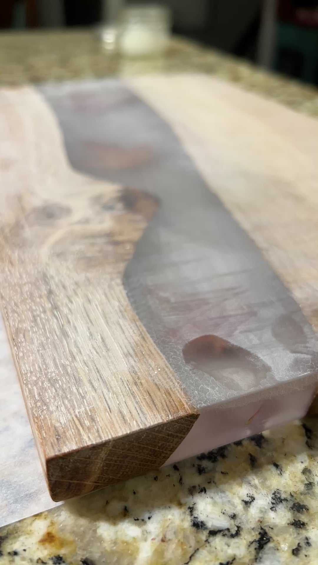 charcuterie board with leaves inside clear epoxy